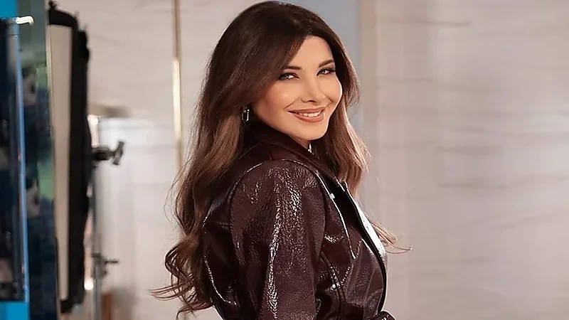 نانسي عجرم تخطف الأنظار بإطلالة جلدية برغندية في المملكة.. وترد على شائعات انفصالها