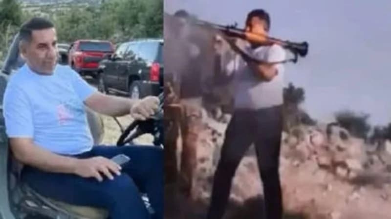 سفير العراق في لبنان يحمل قذيفة "آر بي جي" حربية