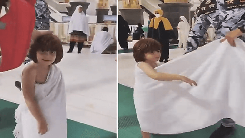 مشهد نبيل لأحد حراس الحرم المكي وهو يساعد طفل في ارتداء الإحرام